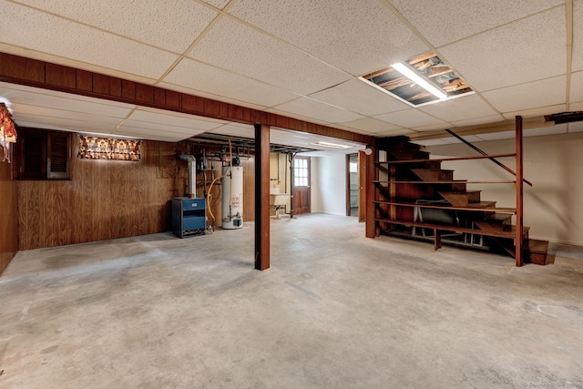 394 Mcclintock St, New Britain, CT 06053 - basement with a paneled ceiling, water heater, stairway, and wooden walls