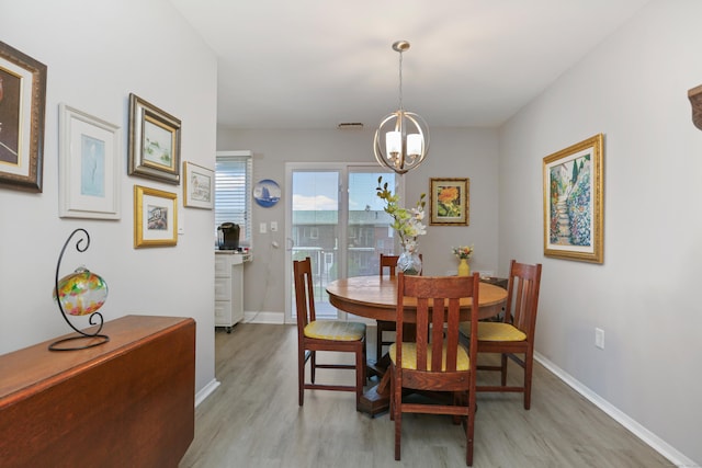 87 E Broadway Unit D, Milford, CT 06460 - dining space with light wood finished floors, a chandelier, and baseboards