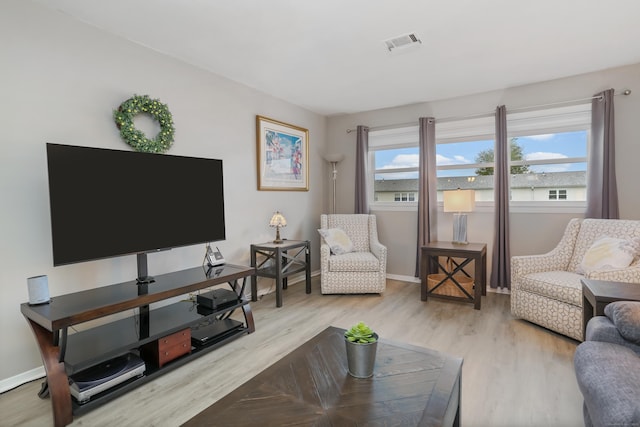 87 E Broadway Unit D, Milford, CT 06460 - living area with wood finished floors, plenty of natural light, and baseboards
