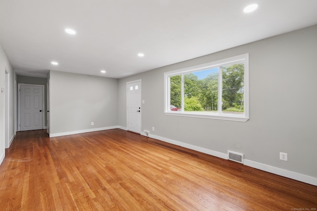 spare room featuring recessed lighting, baseboards, and light wood-style flooring
