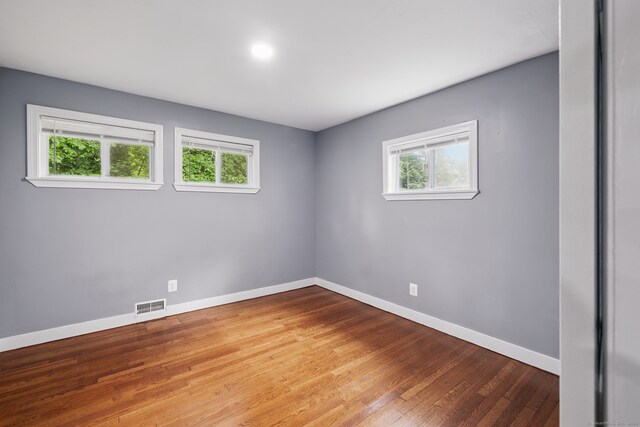 empty room with baseboards and wood finished floors