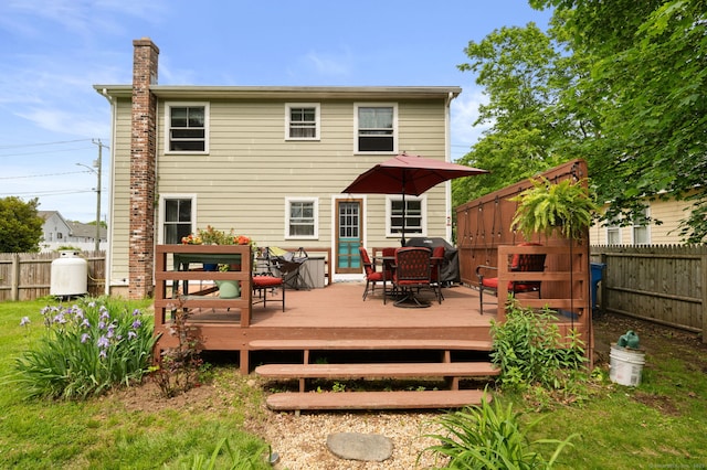 8 Maple Ave, Clinton, CT 06413 - back of property featuring a fenced backyard, a deck, and a chimney