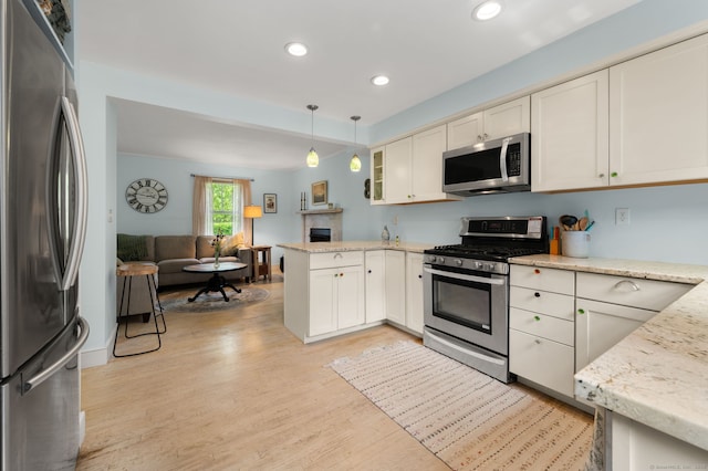 8 Maple Ave, Clinton, CT 06413 - kitchen with stainless steel appliances, open floor plan, light wood finished floors, a peninsula, and recessed lighting