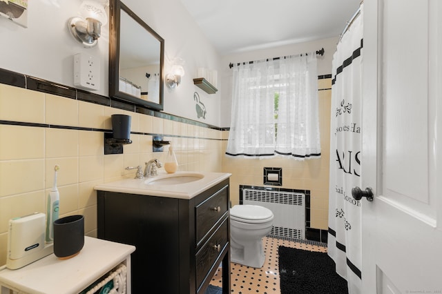 8 Maple Ave, Clinton, CT 06413 - bathroom with radiator, tile walls, toilet, vanity, and tile patterned flooring