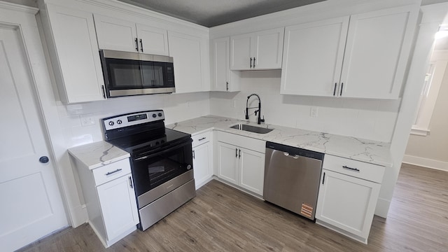 82 Windsor St, Enfield, CT 06082 - kitchen with appliances with stainless steel finishes, a sink, backsplash, and wood finished floors
