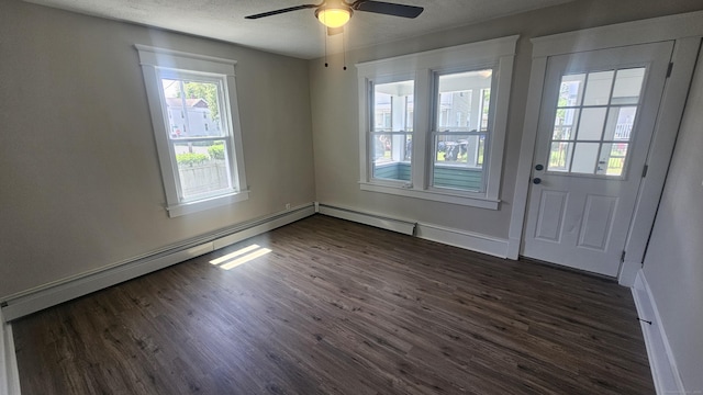 82 Windsor St, Enfield, CT 06082 - spare room with dark wood-style flooring, a ceiling fan, a textured ceiling, baseboards, and a baseboard heating unit