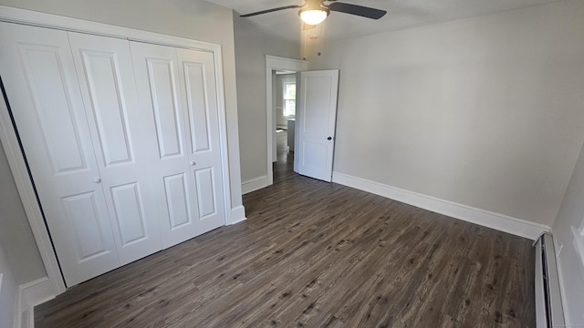 82 Windsor St, Enfield, CT 06082 - unfurnished bedroom with a closet, dark wood-style floors, baseboards, a ceiling fan, and a baseboard heating unit