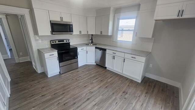 82 Windsor St, Enfield, CT 06082 - kitchen featuring stainless steel appliances, a sink, white cabinets, and light wood finished floors