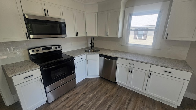 82 Windsor St, Enfield, CT 06082 - kitchen with stainless steel appliances, a sink, white cabinetry, and dark wood-style floors