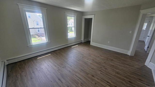 82 Windsor St, Enfield, CT 06082 - empty room featuring dark wood-style floors, baseboards, baseboard heating, and a textured ceiling