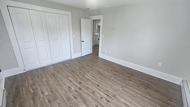 82 Windsor St, Enfield, CT 06082 - unfurnished bedroom featuring wood finished floors, baseboards, a closet, and baseboard heating