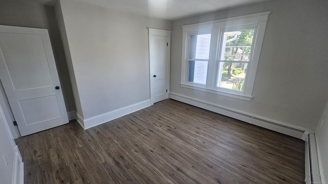 82 Windsor St, Enfield, CT 06082 - unfurnished bedroom featuring dark wood finished floors, baseboards, and a baseboard radiator