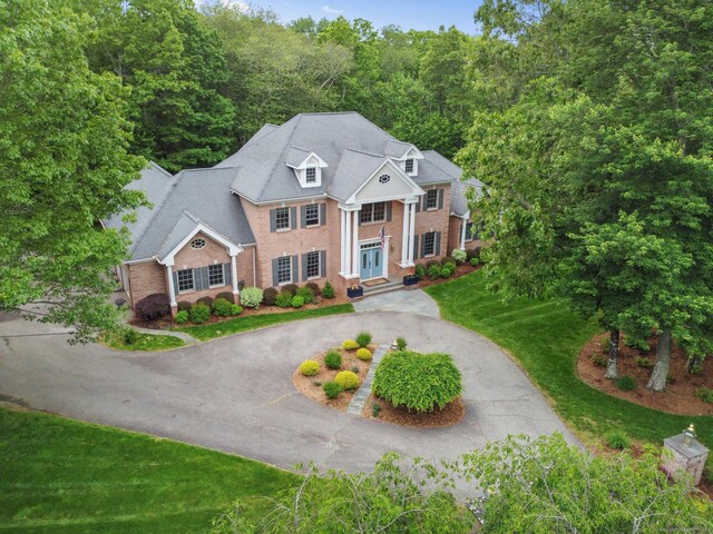 36 Fox Mdw, Marlborough, CT 06447 - neoclassical home featuring brick siding, curved driveway, and a wooded view