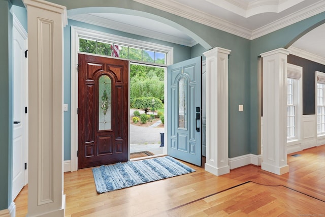 36 Fox Mdw, Marlborough, CT 06447 - foyer entrance with light wood-style flooring, arched walkways, ornate columns, crown molding, and baseboards