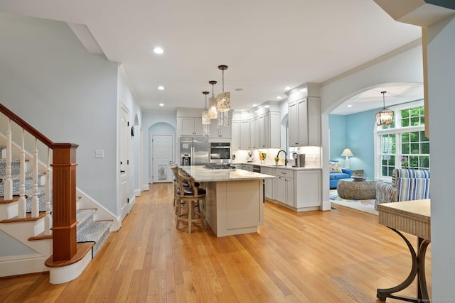 36 Fox Mdw, Marlborough, CT 06447 - kitchen with a chandelier, stainless steel appliances, arched walkways, light wood-style floors, and recessed lighting