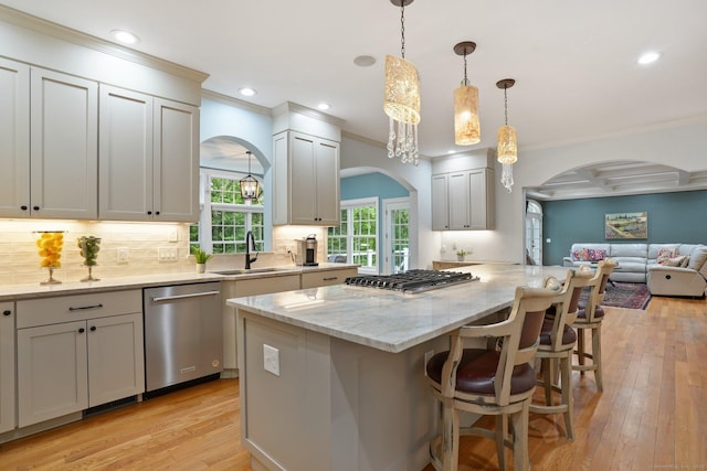 36 Fox Mdw, Marlborough, CT 06447 - kitchen with appliances with stainless steel finishes, arched walkways, a sink, light wood-style floors, and a kitchen breakfast bar
