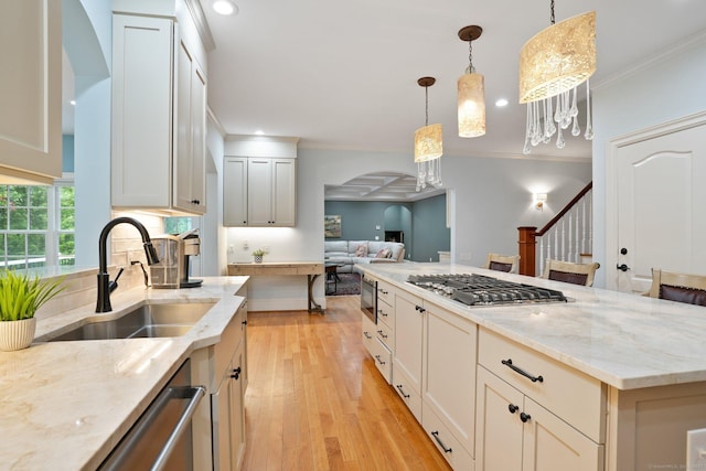 36 Fox Mdw, Marlborough, CT 06447 - kitchen featuring a sink, appliances with stainless steel finishes, arched walkways, open floor plan, and ornamental molding