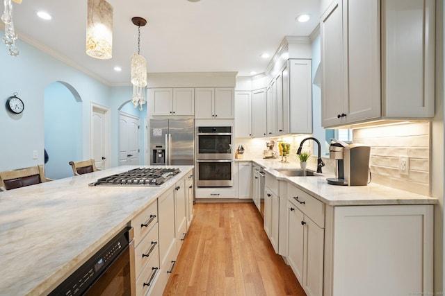 36 Fox Mdw, Marlborough, CT 06447 - kitchen featuring stainless steel appliances, ornamental molding, a sink, arched walkways, and hanging light fixtures