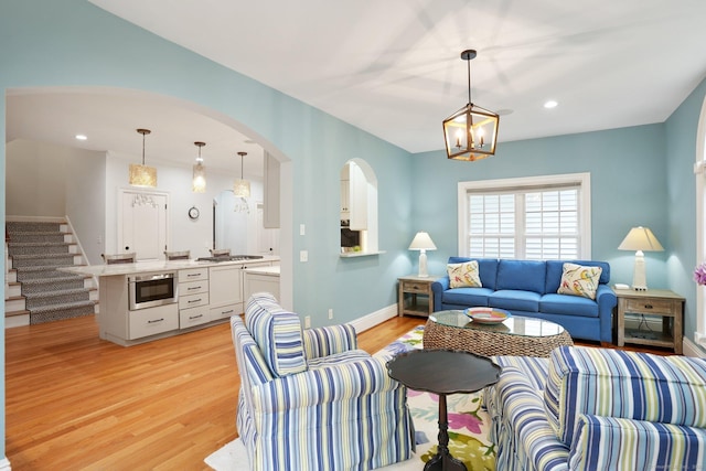 36 Fox Mdw, Marlborough, CT 06447 - living area featuring light wood-type flooring, a chandelier, stairway, recessed lighting, and arched walkways