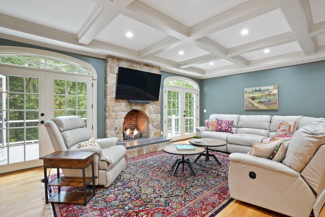 36 Fox Mdw, Marlborough, CT 06447 - living area featuring french doors, coffered ceiling, wood finished floors, beam ceiling, and a stone fireplace
