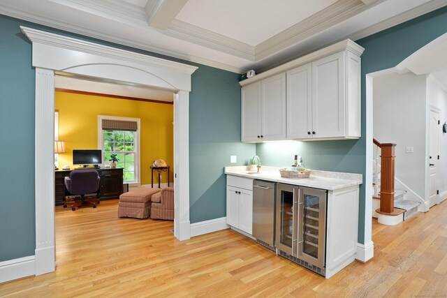 36 Fox Mdw, Marlborough, CT 06447 - indoor dry bar with beverage cooler, crown molding, light wood-type flooring, baseboards, and stairs