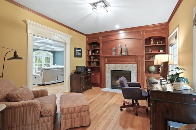 36 Fox Mdw, Marlborough, CT 06447 - office area featuring crown molding, a fireplace with flush hearth, light wood-type flooring, and built in features