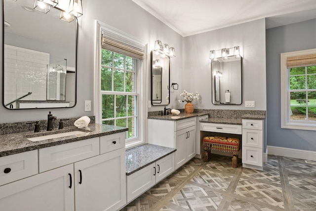 36 Fox Mdw, Marlborough, CT 06447 - bathroom with a tile shower, two vanities, and baseboards