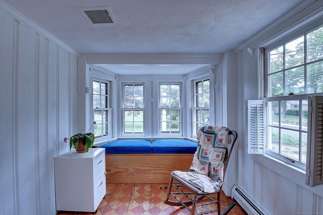 34 N Main St, Marlborough, CT 06447 - sitting room with healthy amount of natural light, light floors, a baseboard radiator, a decorative wall, and a textured ceiling