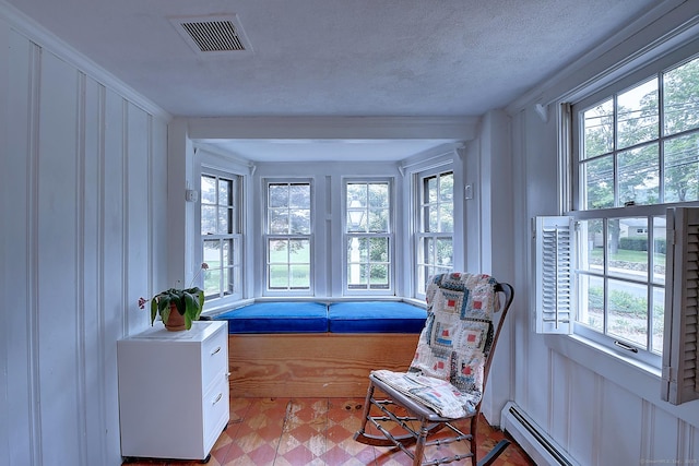 34 N Main St, Marlborough, CT 06447 - living area featuring healthy amount of natural light, light floors, a decorative wall, and baseboard heating