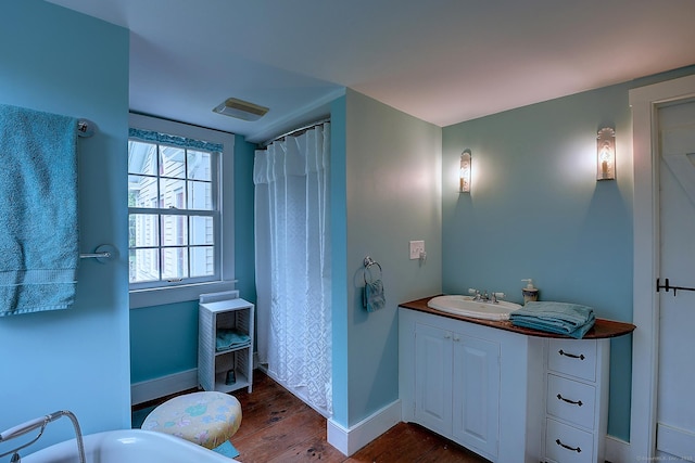 34 N Main St, Marlborough, CT 06447 - full bath with wood finished floors, baseboards, vanity, and a tub to relax in