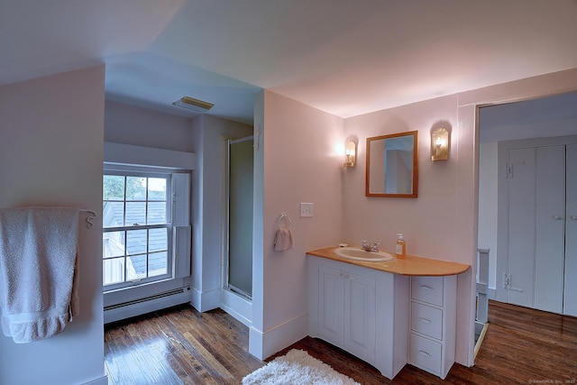 34 N Main St, Marlborough, CT 06447 - bathroom with a baseboard heating unit, wood finished floors, vanity, and a shower stall