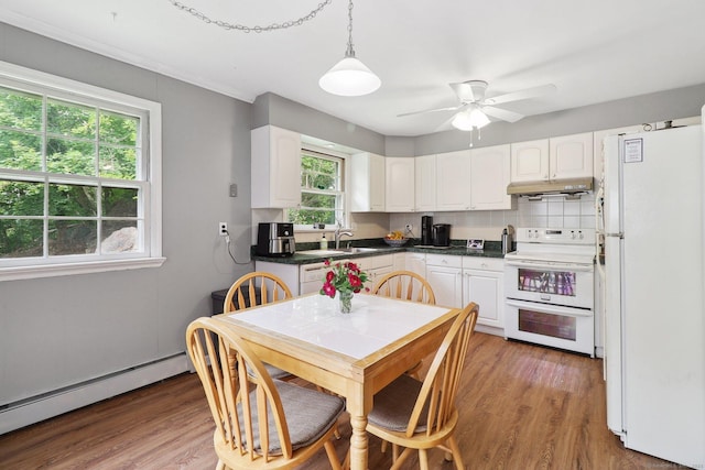 17 Linden St, Norwalk, CT 06851 - kitchen featuring white appliances, baseboard heating, under cabinet range hood, white cabinetry, and ornamental molding