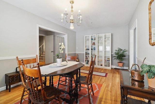 17 Linden St, Norwalk, CT 06851 - dining room featuring a chandelier, stairs, and light wood-style floors