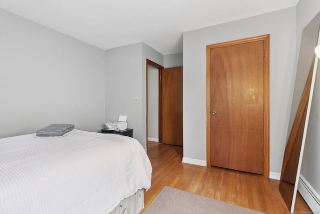 17 Linden St, Norwalk, CT 06851 - bedroom featuring baseboard heating, wood finished floors, and baseboards