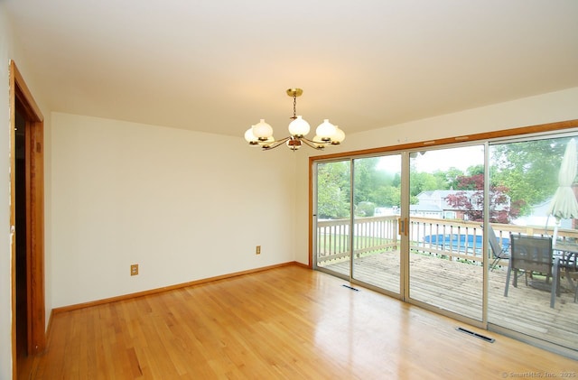 65 Bayberry Dr, Wallingford, CT 06492 - empty room featuring a chandelier, baseboards, and light wood-type flooring