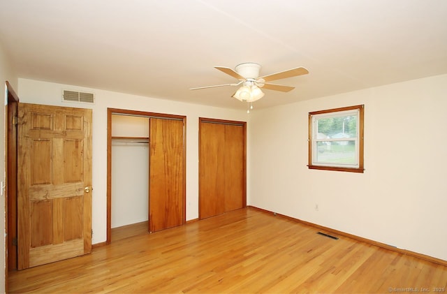 65 Bayberry Dr, Wallingford, CT 06492 - unfurnished bedroom featuring multiple closets, light wood-style floors, ceiling fan, and baseboards