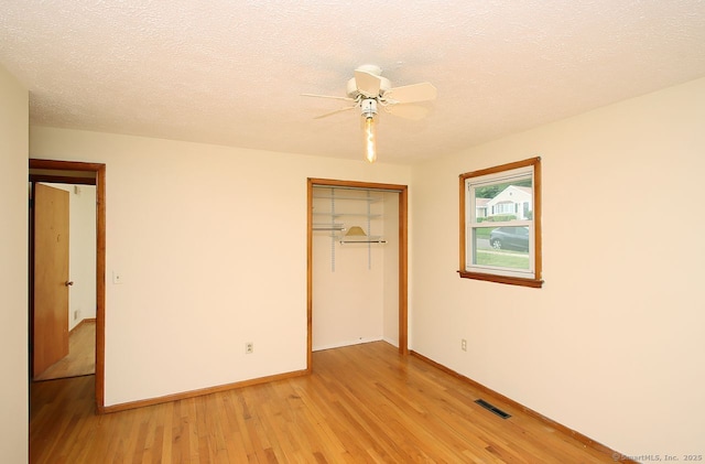 65 Bayberry Dr, Wallingford, CT 06492 - unfurnished bedroom featuring light wood finished floors, a closet, baseboards, a textured ceiling, and a ceiling fan