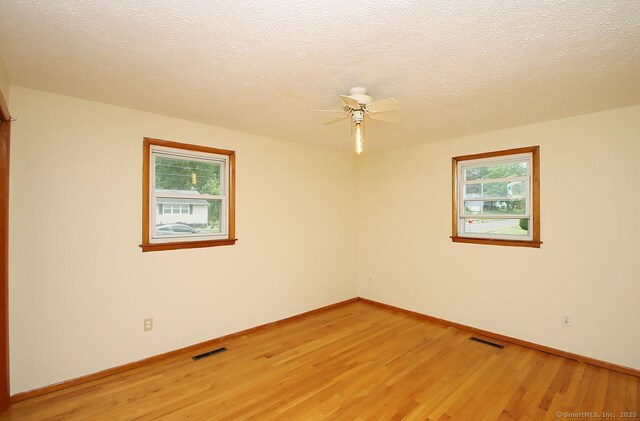65 Bayberry Dr, Wallingford, CT 06492 - empty room with light wood-type flooring, baseboards, ceiling fan, and a textured ceiling