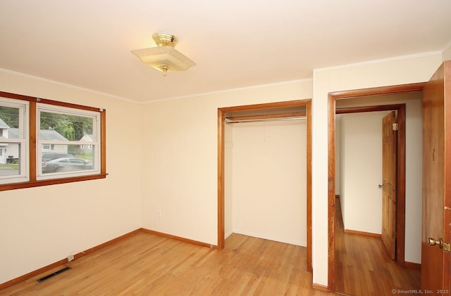 65 Bayberry Dr, Wallingford, CT 06492 - unfurnished bedroom featuring light wood-type flooring, a closet, baseboards, and ornamental molding