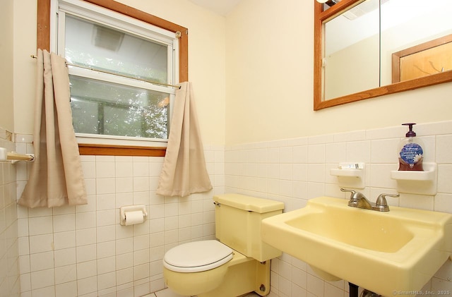 65 Bayberry Dr, Wallingford, CT 06492 - bathroom featuring tile walls, toilet, a wainscoted wall, and a sink