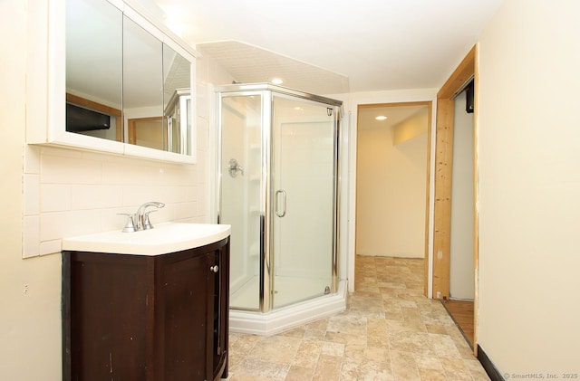 65 Bayberry Dr, Wallingford, CT 06492 - bathroom featuring vanity, a shower stall, stone finish flooring, and tasteful backsplash