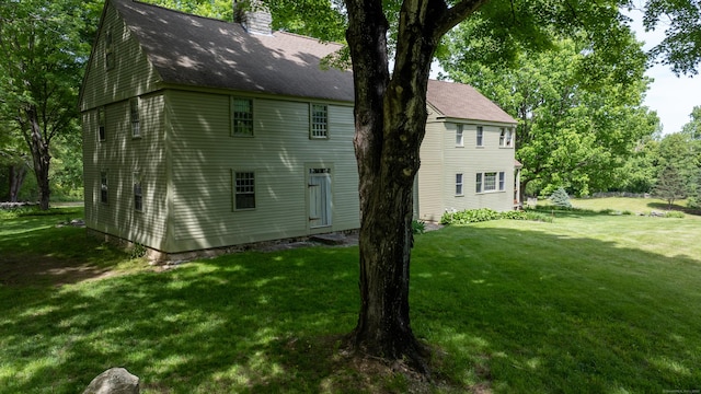 310 S Bigelow Rd, Hampton, CT 06247 - view of side of home featuring a lawn, a chimney, and roof with shingles
