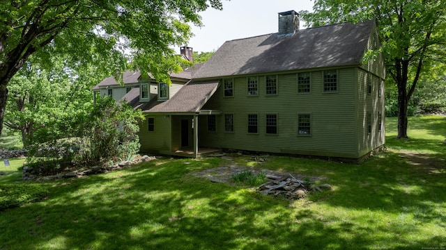 310 S Bigelow Rd, Hampton, CT 06247 - rear view of property with a chimney, a shingled roof, and a lawn