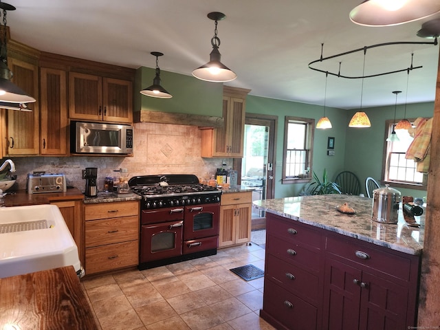 310 S Bigelow Rd, Hampton, CT 06247 - kitchen featuring stainless steel microwave, double oven range, decorative backsplash, and hanging light fixtures