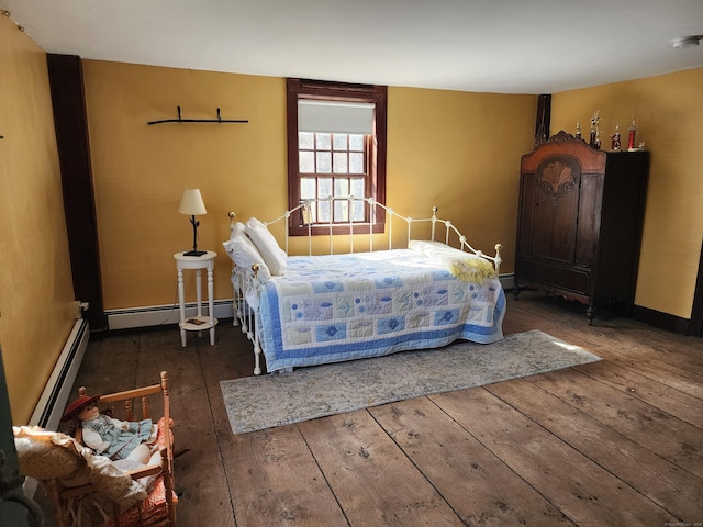 310 S Bigelow Rd, Hampton, CT 06247 - bedroom with a baseboard heating unit and hardwood / wood-style floors
