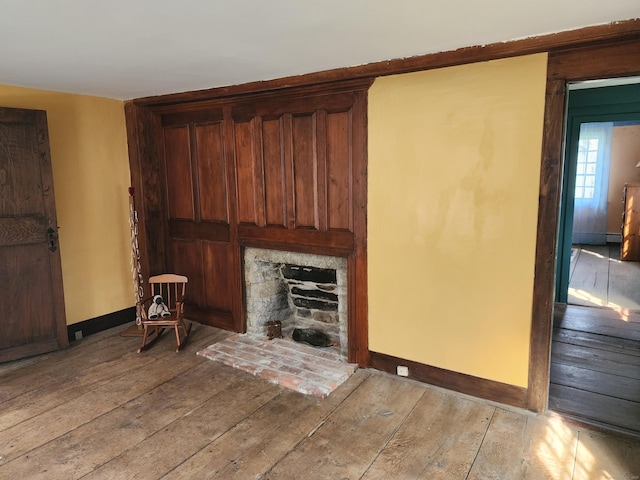 310 S Bigelow Rd, Hampton, CT 06247 - living area featuring light wood-type flooring, a fireplace with raised hearth, and a baseboard radiator