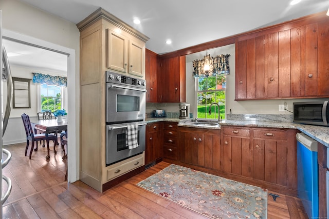 6 Landing Hill Rd, East Haddam, CT 06423 - kitchen featuring stainless steel appliances, a sink, light wood-style flooring, a chandelier, and light stone counters