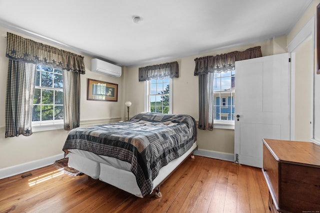 6 Landing Hill Rd, East Haddam, CT 06423 - bedroom featuring an AC wall unit, light wood-style floors, and baseboards