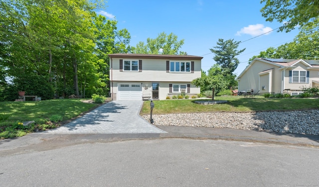 25 Parkwood Ave, Waterbury, CT 06708 - view of front of home with driveway, a front lawn, and a garage