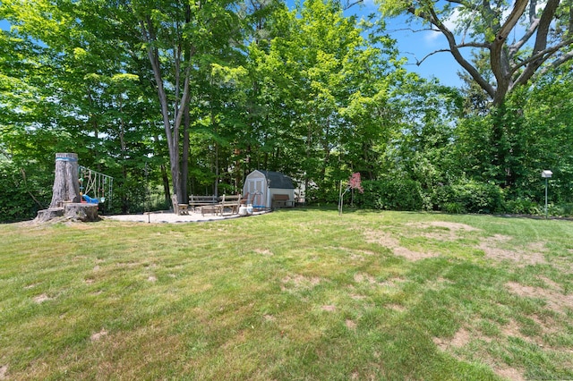 25 Parkwood Ave, Waterbury, CT 06708 - view of grassy yard with a shed and a patio area